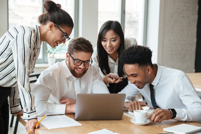happy-young-business-colleagues-using-laptop-computer