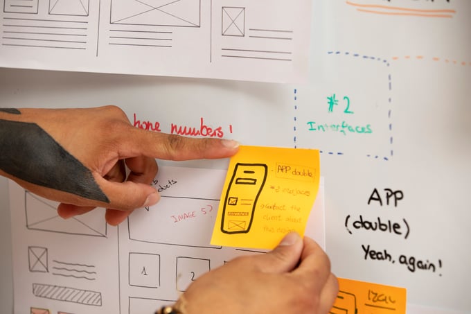 high-angle-hands-holding-post-its