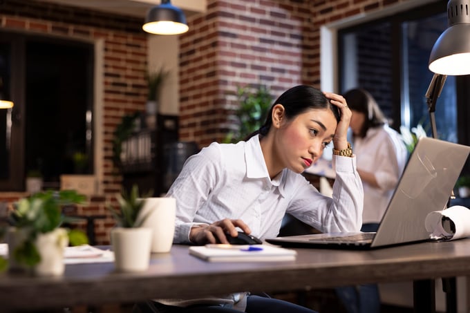 tired-woman-working-late-her-desk
